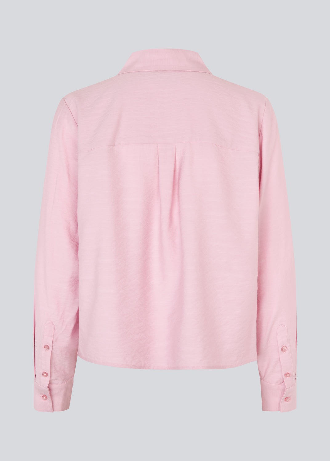 Shirt in light pink/rosa in a light EcoVero viscose with a loose fit. HudgesMD shirt has a collar, button closure in front, and long sleeves with cuffs. 