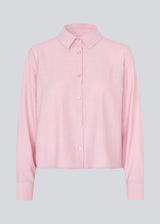 Shirt in light pink/rosa in a light EcoVero viscose with a loose fit. HudgesMD shirt has a collar, button closure in front, and long sleeves with cuffs. 