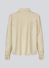 Shirt in beige in a light EcoVero viscose with a loose fit. HudgesMD shirt has a collar, button closure in front, and long sleeves with cuff. 