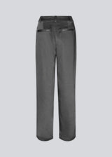 Satin pants with zip fly and button at the waist. HudsonMD pants has a regular waist with pleats, slanted side pockets, and decorative welt back pockets. The model is 175 cm and wears a size S/36.
