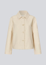 Jacket with loose sleeves, shirt collar, and a button closure in front. IngridMD jacket has raw edges in the front, back, and bottom.