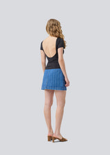 Denim short skirt in cotton denim. IsoldeMD jacquard skirt has an asymmetrical closure in front and is closed with a button.