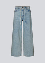 Jeans with wide legs in cotton denim in a light blue wash. IsoldeMD pants have a high waist, front and back pockets and a tie band at the waist.