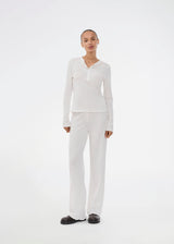 White pointelle pants. Josefinemd pants are feminine pointelle cotton trousers with lace trim and a subtle openwork pattern. Soft, comfortable, and ideal for relaxing at home. Josefine Vogt (165 cm) and the model (177 cm) are both wearing size Small.