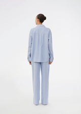 Blue classic striped pyjamas. The pyjamas is sold as a set of shirt and pants in the same size. Josefinemd pyjamas are made from 100% soft cotton and feature a classic fit with a collar, button closure, and drawstring trousers. Finished with delicate wave trim and comes with a matching pouch with logo. Josefine Vogt (165 cm) and the model (177 cm) are both wearing size Small.