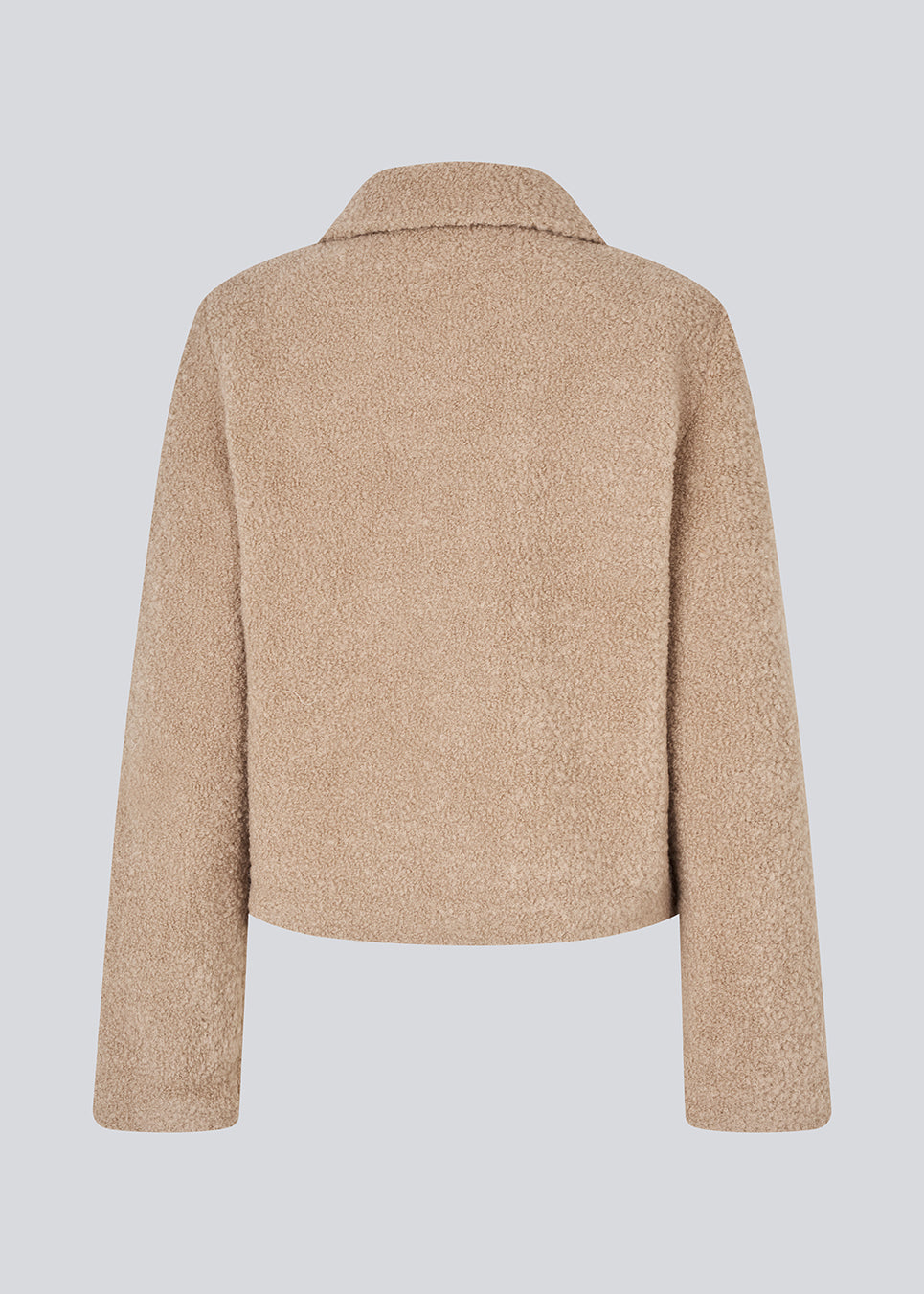 Short beige jacket in a wool mix. JustyMD short jacket has a loose fit, button closure and to pockets in front.