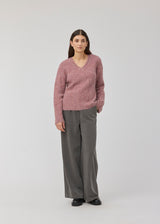 Soft purple knit with a V-neck. KaneMD v-neck has a loose fit and dropped shoulders.