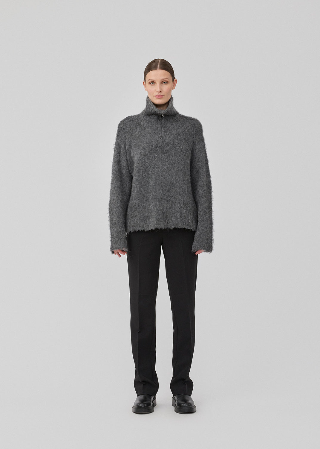 Soft grey knit with a high neck and half zip front. KaneMD v-neck has a loose fit and dropped shoulders.