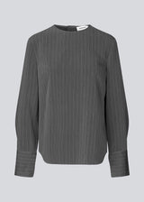 Long dark grey sleeved top with a hidden button closure in the back. KemmaMD top has loose sleeves and a cuff with button closure.