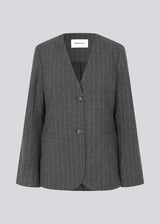 Fitted dark grey blazer in a pinstriped wool mix. KristolMD blazer has shoulder pads, two pockets in front, lining and a slit in the back.