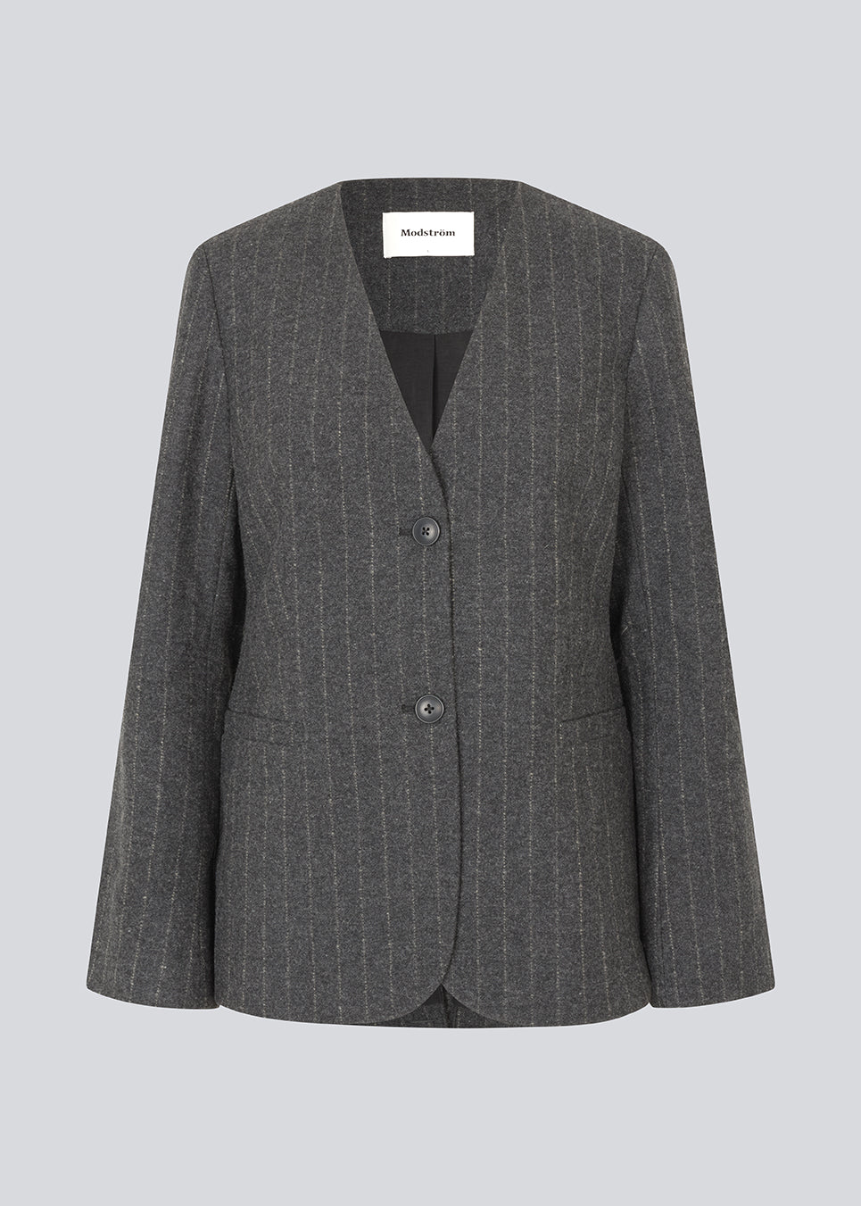 Fitted dark grey blazer in a pinstriped wool mix. KristolMD blazer has shoulder pads, two pockets in front, lining and a slit in the back.