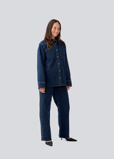 Classic shirt in denim with metal studs details. LuccaMD shirt has a shirtcollar, two front pockets and a button closure.