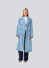 Oversized double-breasted trench coat in denim. MadelineMD denim jacket has dropped shoulders, long wide sleeves and a tieband at the waist.