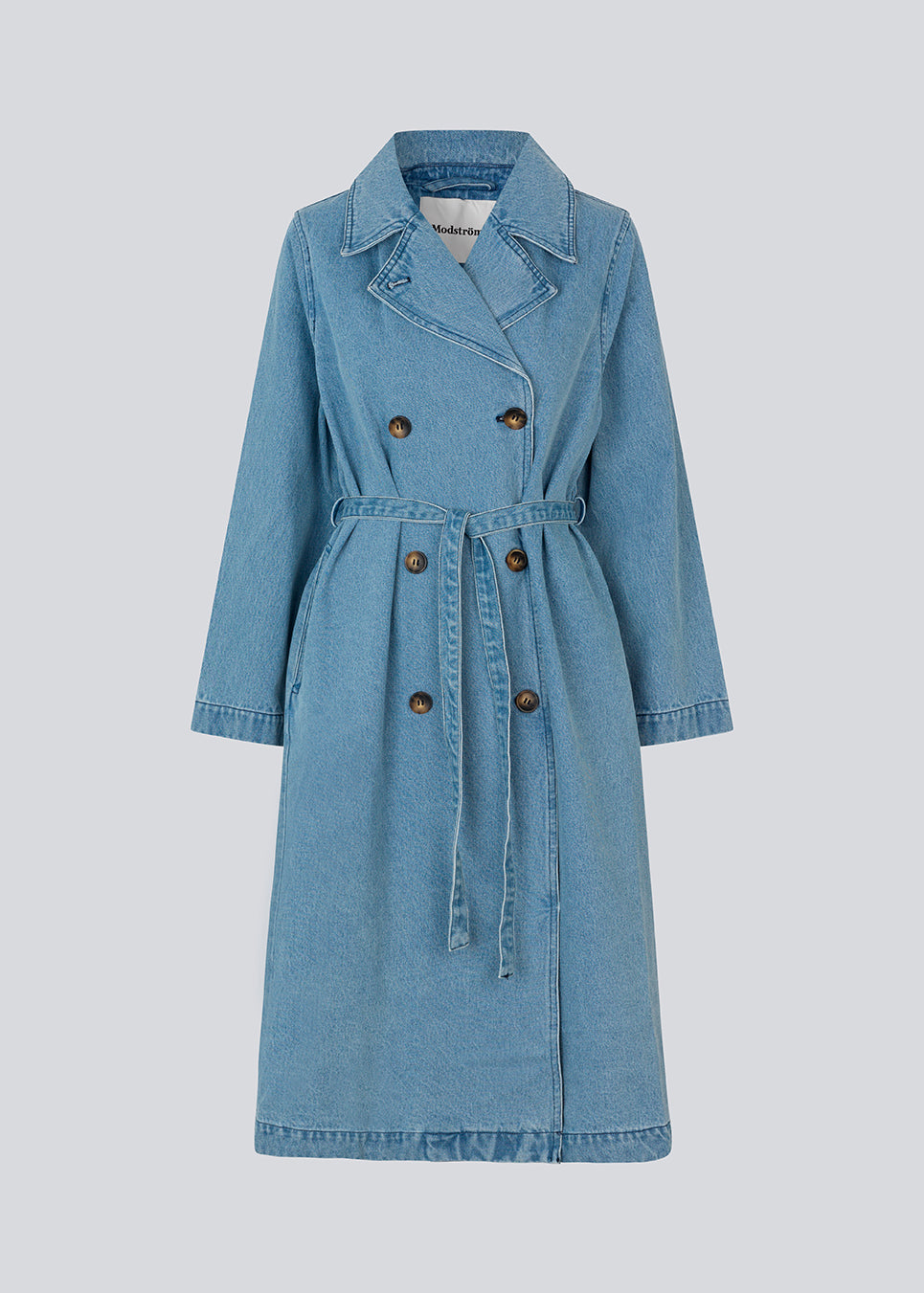 Oversized double-breasted trench coat in denim. MadelineMD denim jacket has dropped shoulders, long wide sleeves and a tieband at the waist.