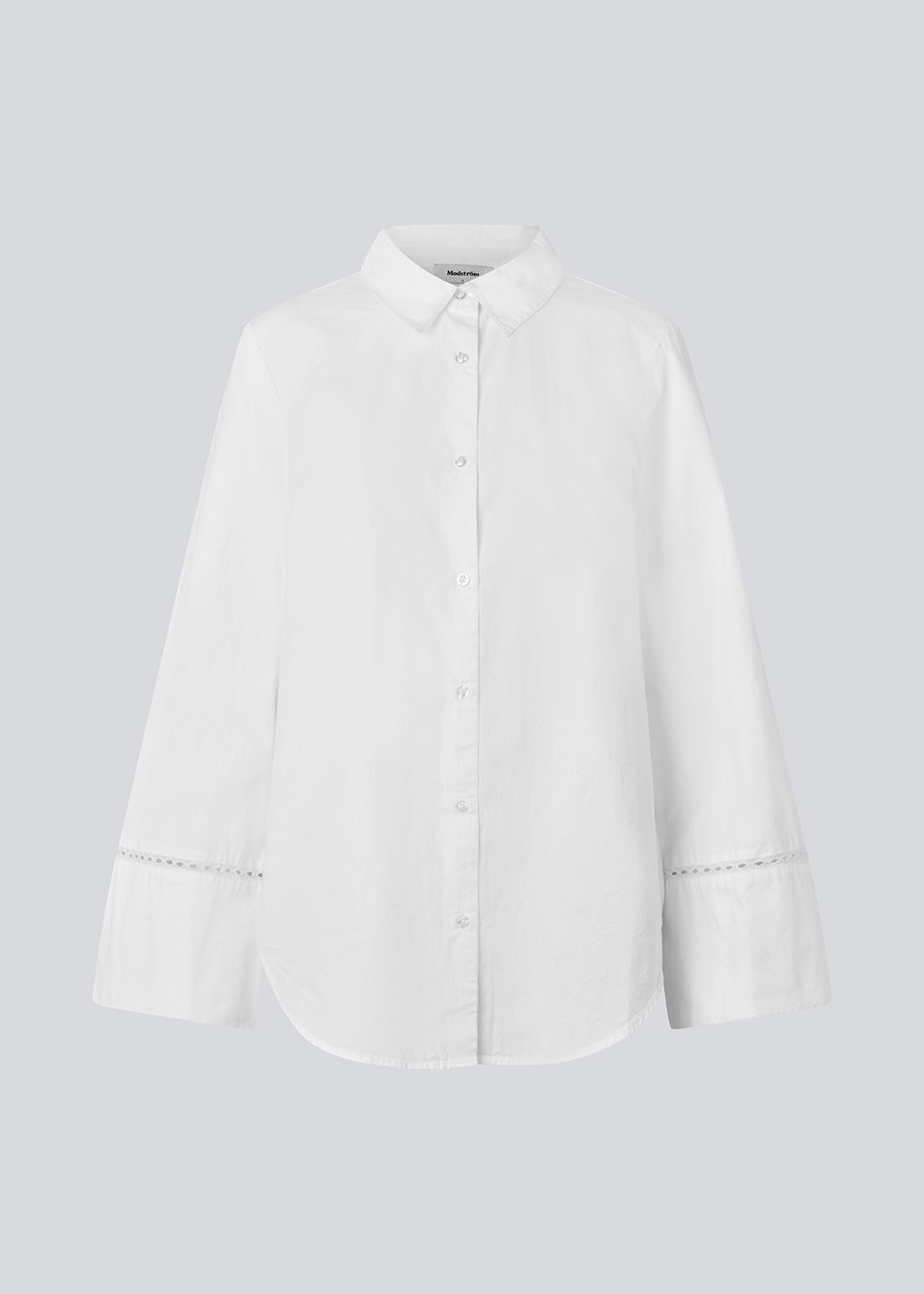 Oversize shirt with broderie anglaise details. MallenMD shirt has long wide sleeves with slits, shirtcollar and a button closure in front.