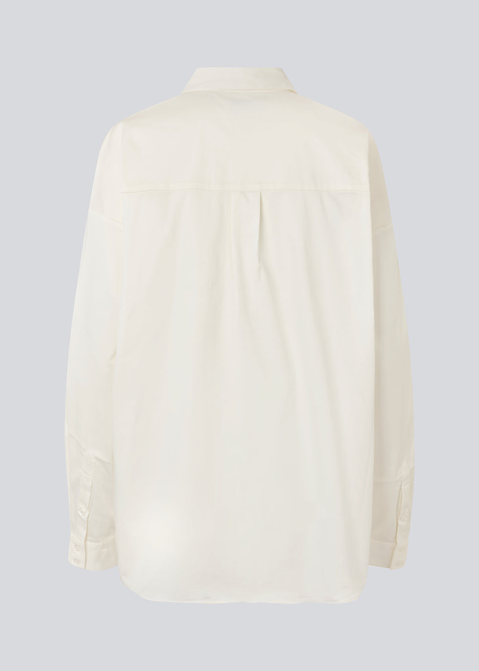 Classic shirt in white with an oversized fit. MallinMD shirt has a collar and a hidden button closure. 