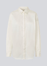 Classic shirt in white with an oversized fit. MallinMD shirt has a collar and a hidden button closure. 