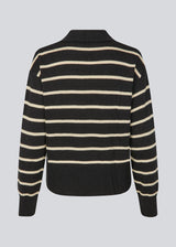 Soft knitted polo in black with white stripes in plain jersey knit. MalvaMD stripe polo has a collar and a button closure in front. The model is 177 cm and wears a size S/36.
The knit is small and slightly cropped.
