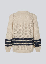 Loose knitted cardigan in beige with navy blue stripes in the button in cable knit. MetteMD cardigan is slightly see-through and has loose sleeves and a button closure. The models are 177 cm and wear a size S/36. 