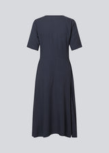 Long dress with short sleeves and a v-neck. MiguelMD SS dress has smock details and an invisible zipper on the side.