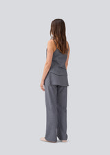 Sleeveles top with thin straps and a button closure. MikkelineMD top has two pocket and a hidden button closure in front.