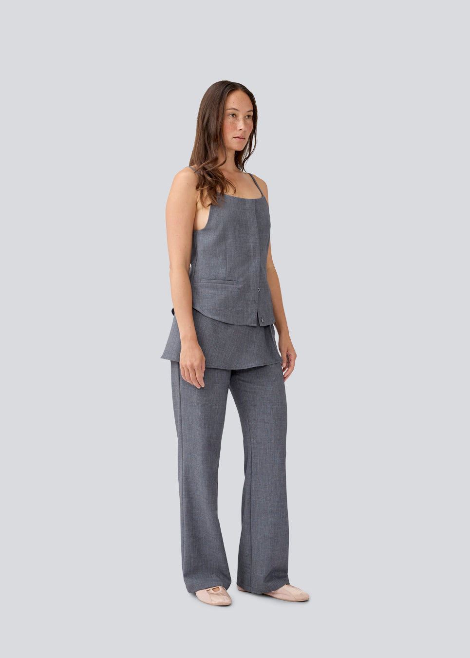 Sleeveles top with thin straps and a button closure. MikkelineMD top has two pocket and a hidden button closure in front.