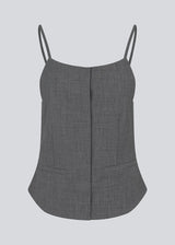 Sleeveles top with thin straps and a button closure. MikkelineMD top has two pocket and a hidden button closure in front.
