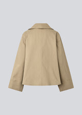Beige jacket with an asymetrical closure. MillaMD jacket has two pockets in front, collar and wide sleeves.