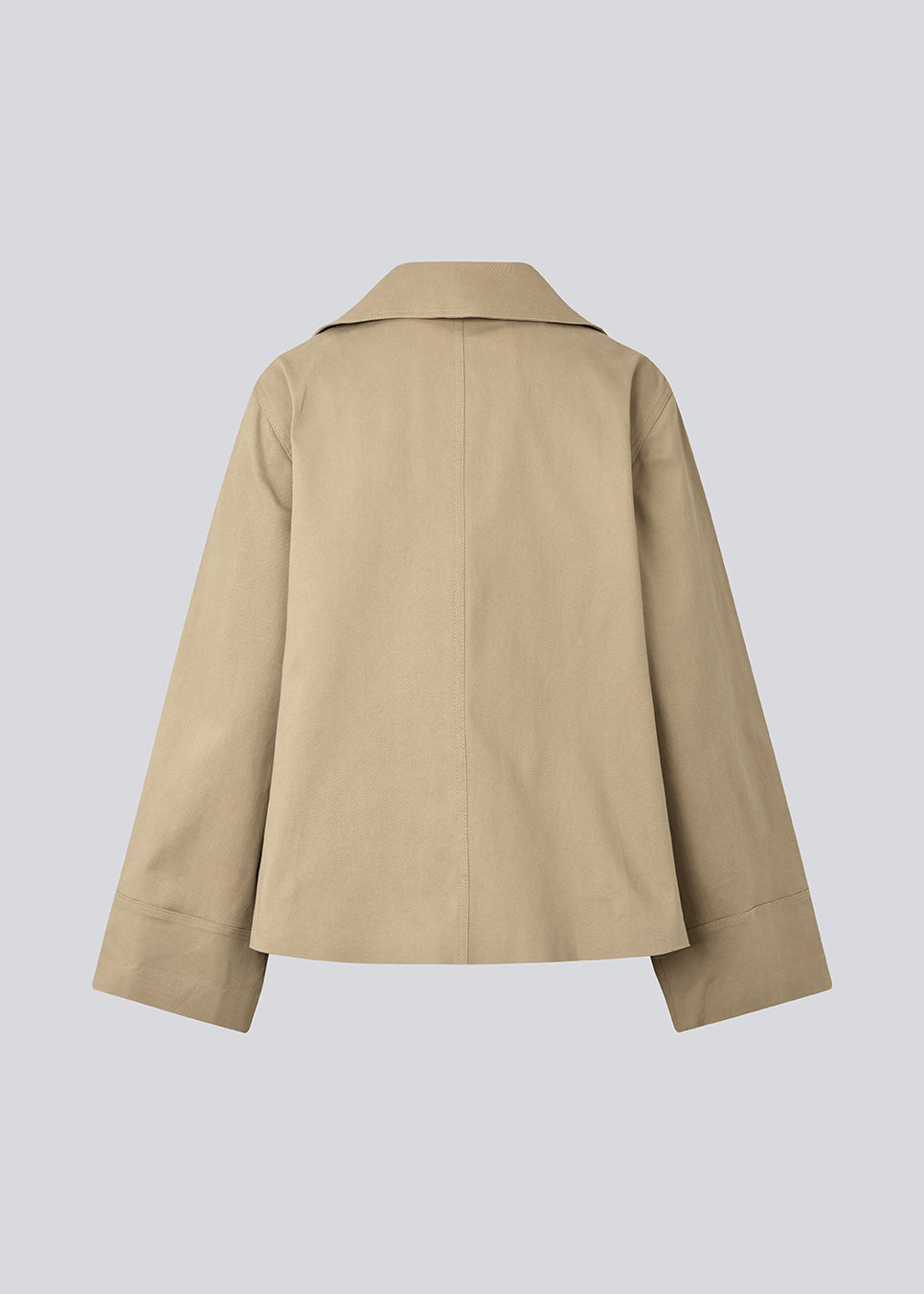 Beige jacket with an asymetrical closure. MillaMD jacket has two pockets in front, collar and wide sleeves.