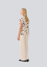 Sleeveless top with frill details. MistMD SS top has a loose fit and a button closure with frill details in front.