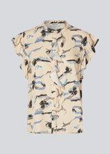 Sleeveless top with frill details. MistMD SS top has a loose fit and a button closure with frill details in front.