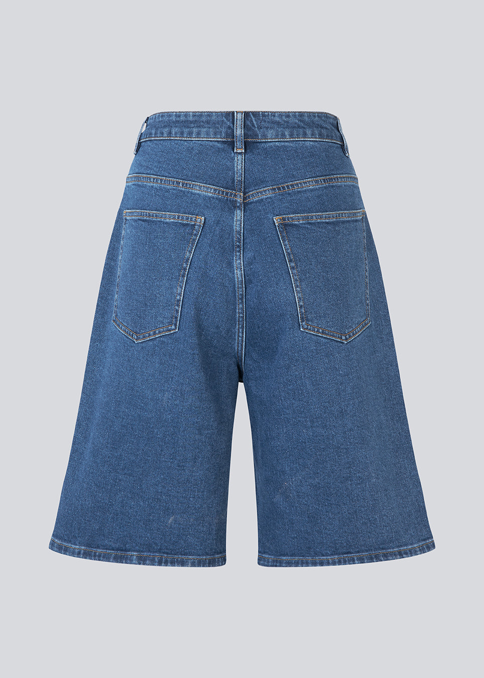 Long shorts with wide legs in cotton denim. NadjaMD solid shorts have a zipper fly, a high waist, and front and back pockets.