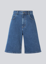 Long shorts with wide legs in cotton denim. NadjaMD solid shorts have a zipper fly, a high waist, and front and back pockets.