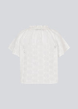 Top with short sleeves in broderie anglaise. NanetteMD SS top has a loose fit and an opening in front with a button closure.