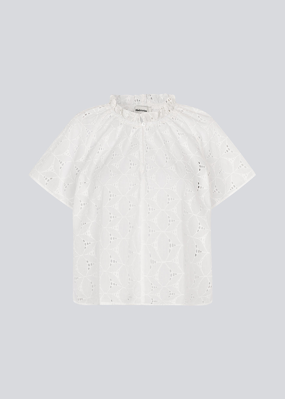 Top with short sleeves in broderie anglaise. NanetteMD SS top has a loose fit and an opening in front with a button closure.