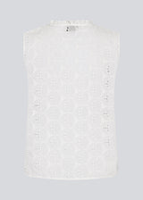 Sleeveless white top in broderie anglaise. NanetteMD top has a high neck and a button closure in front.