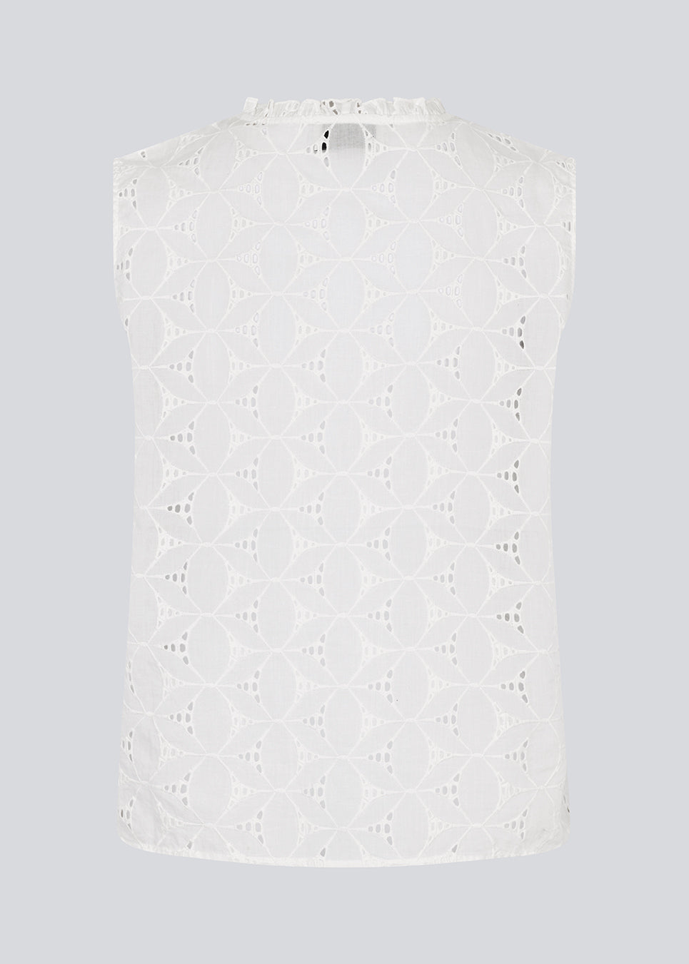 Sleeveless white top in broderie anglaise. NanetteMD top has a high neck and a button closure in front.