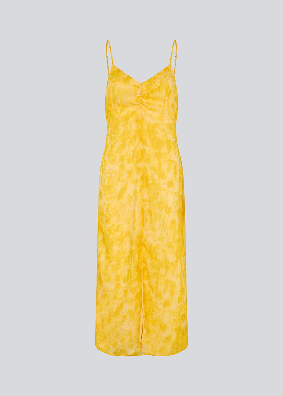 Maxi dress in yellow with thin straps and an elastic gathering at the chest. Napthalimd print strap dress has a slit in the front and an invisible zipper at the back.