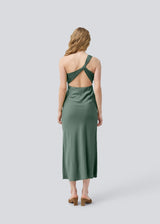 Long one shoulder dress in green in satin. NarcissaMD dress has an open back with beautiful details and an invisible zipper in the side.
