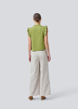 Sleeveless top in green with frill details and a loose fit. NarcissaMD top has frills at the sleeves and neckline, and an opening in front with a tieband closure.
