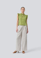 Sleeveless top in green with frill details and a loose fit. NarcissaMD top has frills at the sleeves and neckline, and an opening in front with a tieband closure.
