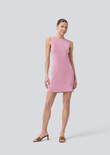 Short pink fitted dress in shimmery knit. NavalMD dress is sleeveless and has a round neckline.