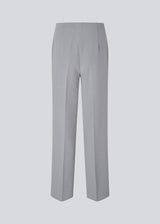 Classic pants in grey with pressfolds and straight legs. Nelli pants are closed by an hidden zipper at the side with an elastic waistband for a more comfortable fit. 