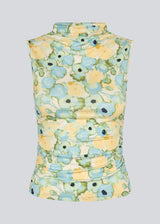 fitted top in an elastic material. NettieMD print top is sleeveless, has a high neckline, and has gatherings in the side