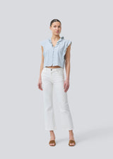 Sleeveless top with frill details and a button closure in front with stripes. NikkoMD top is slightly cropped and has a v-neck.