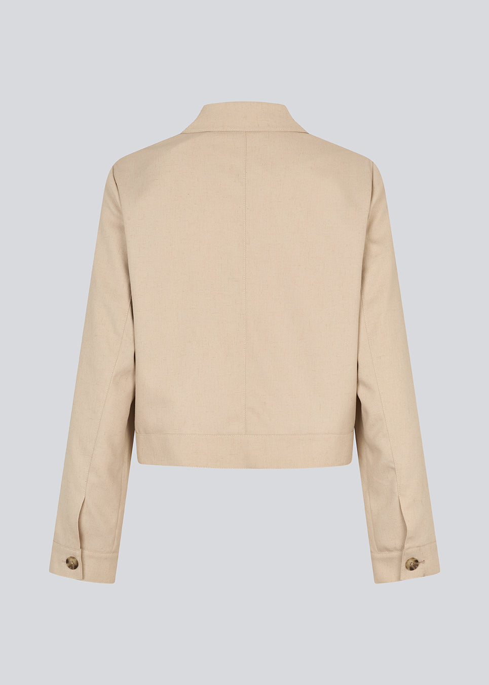 Short beige jacket with a shirt collar and wide sleeves. NormaMD jacket hasa button closure in front and two front pockets.