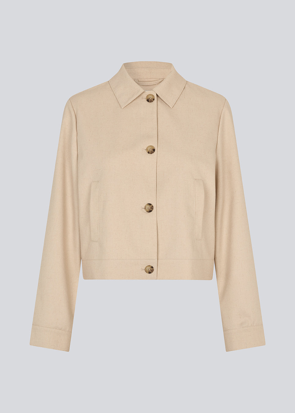 Short beige jacket with a shirt collar and wide sleeves. NormaMD jacket hasa button closure in front and two front pockets.