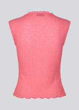 Sleeveless top in a structured material with a high neck.