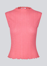 Sleeveless top in a structured material with a high neck.