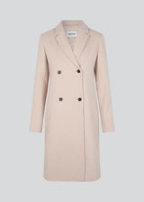Beautiful, knee-length wool coat. Odelia coat, in season color Summer Sand, is closed at front by 4 buttons and is fitted around the waist, which gives a feminine look. Because of the high content of wool the jacket will be perfect for fall and the mild winters.